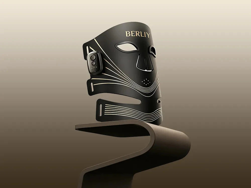 Black BERLIY LED mask on a display stand, showing the connected face and neck panels and side controller.