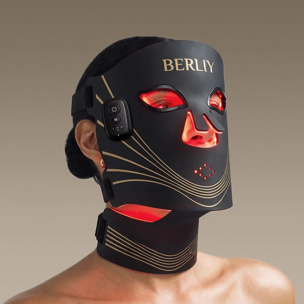 Woman wearing the black BERLIY face and neck mask with red light visible around the eyes and neck.